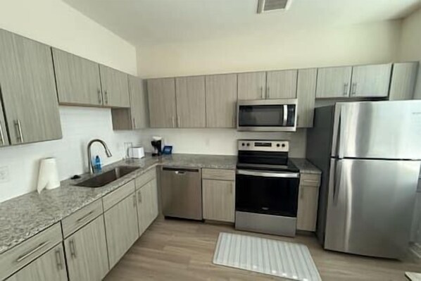 Fridge, stovetop, dishwasher, coffee/tea maker