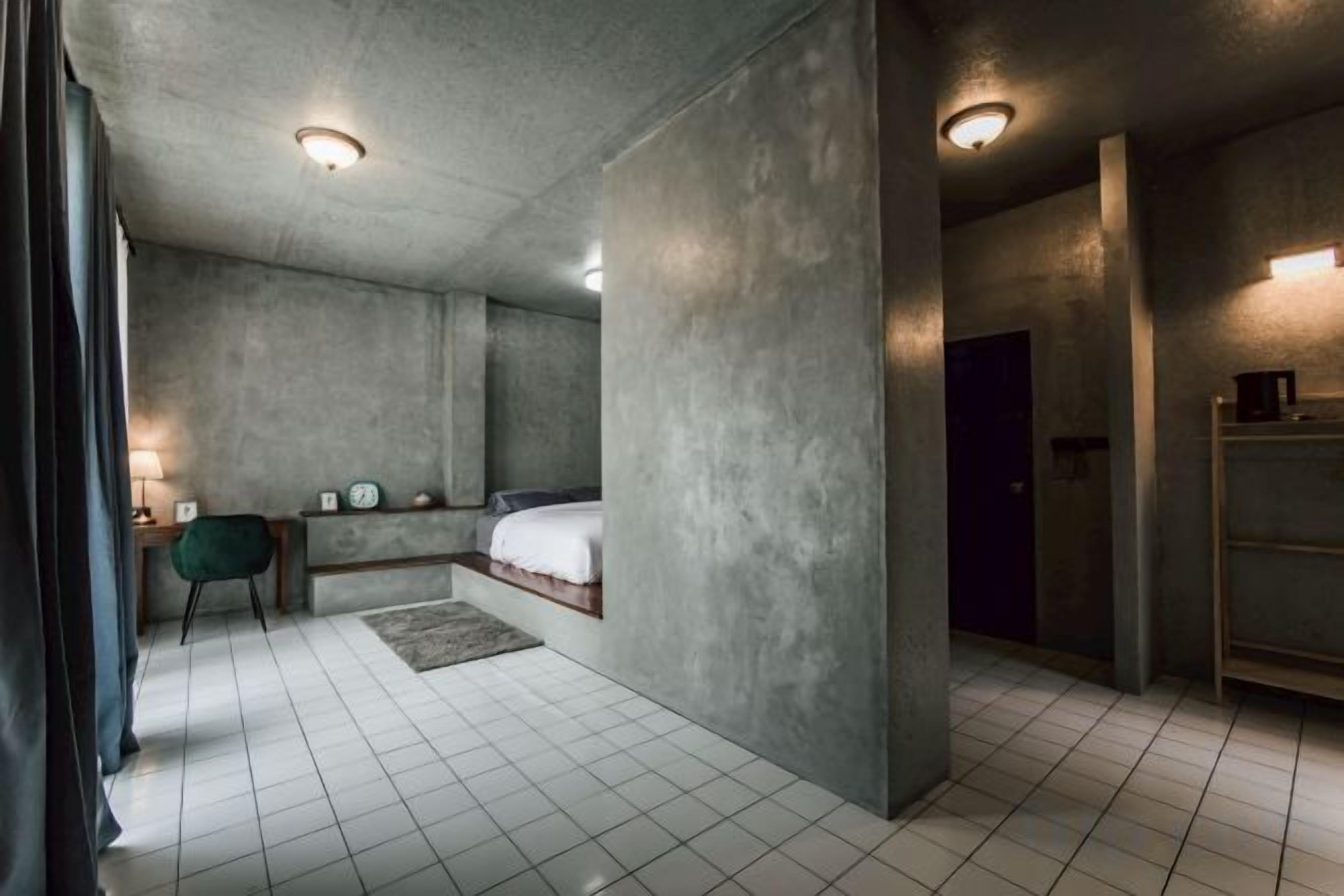 A modern bedroom with a bed, bedside tables, and a nightstand.