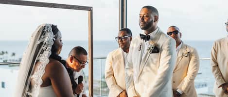 A wedding ceremony with a view of the ocean.