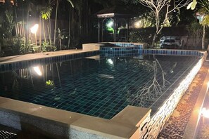 A swimming pool with a tiled edge, surrounded by plants and a gazebo. - Moubillow Resort (Krabi)