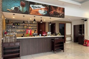 A bar area with a counter, shelves with beverages, and hanging lights. - Vienna Royal Hotel Bac Ninh (Bac Ninh)