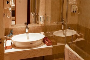 A bathroom with two sinks, a mirror, and a shower. - Vienna Royal Hotel Bac Ninh (Bac Ninh)