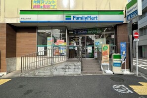 The entrance to a FamilyMart store with a ramp leading up to the entrance, a sign indicating 24-hour operation, and a no-entry sign on the right. - 3 Guests Kitchen & Washer 7-min Walk to Waseda University (Tokyo)
