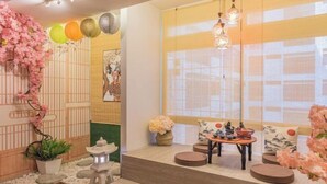 A traditional Japanese-style room with tatami flooring, a low table with a tea set, and a shoji screen door. - Fahrenheit88-Ancient Loft House ( Japan Theme ) (Kuala Lumpur)