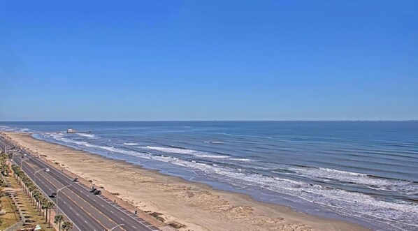 A coastal road with a beach and ocean.