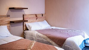 A room with two beds, each with a wooden headboard and a headboard shelf. - Hotel Boutique Cielito Lindo (Jilotepec)