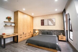 A modern bedroom with a bed, wooden wardrobe, desk, and bedside tables. - Merci Hoang Huy Riverside Hai Phong (Haiphong)