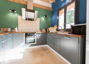 A modern kitchen with a built-in oven, microwave, and sink. - Castel Ginest - LAHAGE (LAHAGE)