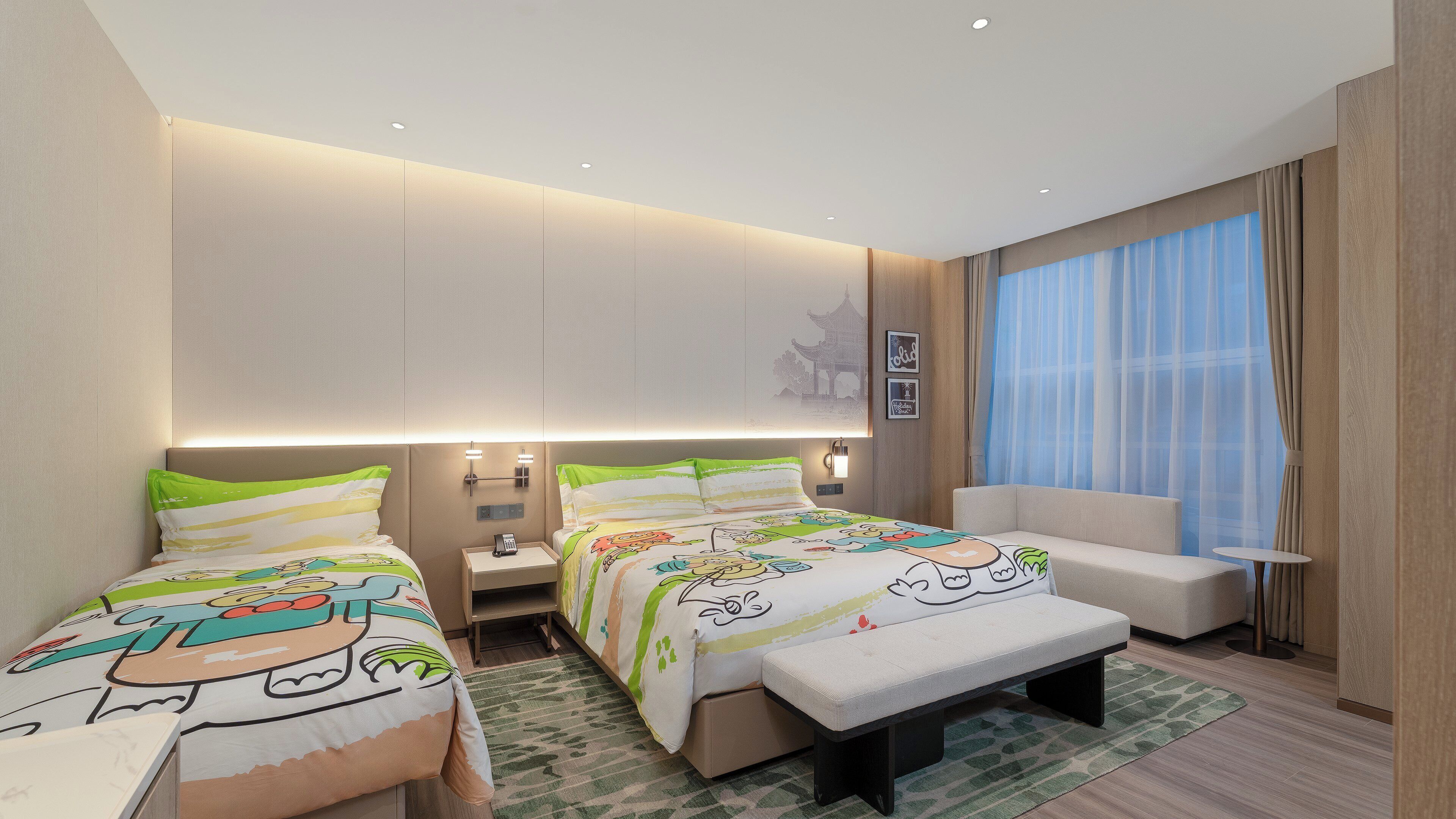 A hotel room with two beds, a sofa, a small table, and a window with curtains.