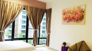 A hotel room with two beds, large windows with curtains, a painting on the wall, and a small table with a plant. - Electus Home at Midhills Genting - Free WiFi & Parking (Genting Highlands)