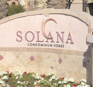 A sign for Solana Condominium Homes with a curved top and a floral border at the bottom. - Gilbert/Mesa 2 Bedroom Condo, right next to heated pool! (Mesa)