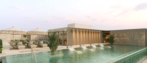 Una piscina al aire libre, camas de piscina gratis, sombrillas