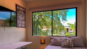 A bedroom with a bed, a desk, and a chair. - Family Oasis w/ Full A/C • Pools & 24/7 Security (Apopa)