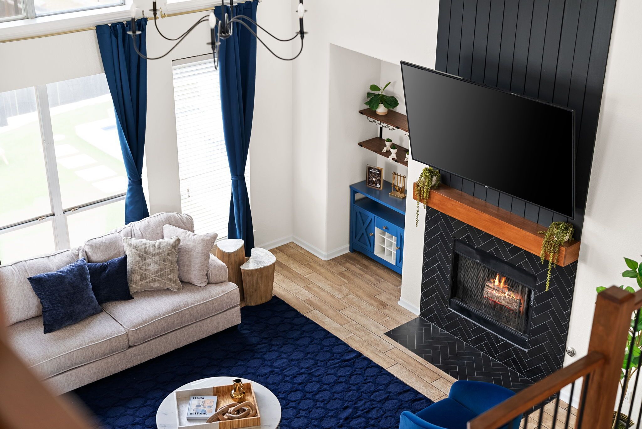 A modern living room with a sofa, coffee table, and a fireplace.