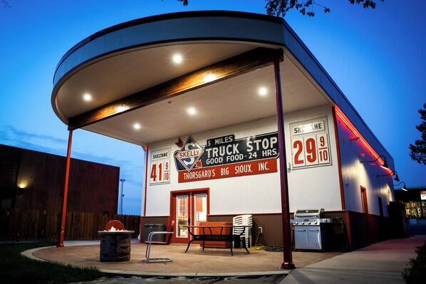 A truck stop with a covered outdoor seating area, a grill, and a sign indicating it's Skelton's Big Sioux, Inc.