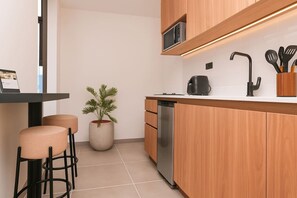 Microwave, coffee/tea maker, cookware/dishes/utensils, dining tables