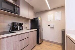 Fridge, microwave, coffee/tea maker, cookware/dishes/utensils