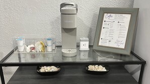 A coffee station with a Keurig machine, cups, and a coffee menu. - Beachside Escape (Corpus Christi)