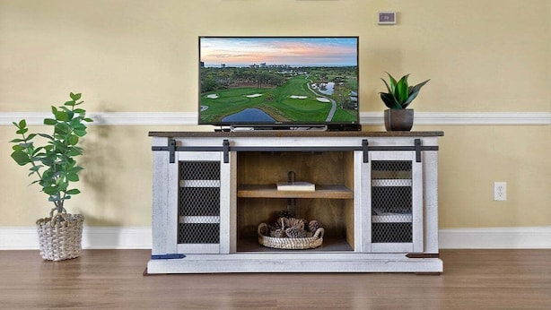 A television on a wooden console with a view of a golf course. - Cozy Ground Floor 3BR Condo at Myrtlewood Golf (Myrtle Beach)