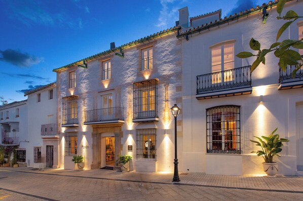 A multi-story building with balconies, a street lamp, and potted plants. - La Fonda Heritage Hotel Relais and Chateaux (Marbella)