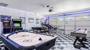 A room with arcade games, a foosball table, and a pool table. - Near Camelback Mtn, Old Town, Trails, Golf + Spas w/ Pool, Hot Tub Camelback Casa by Avantstay (Phoenix)