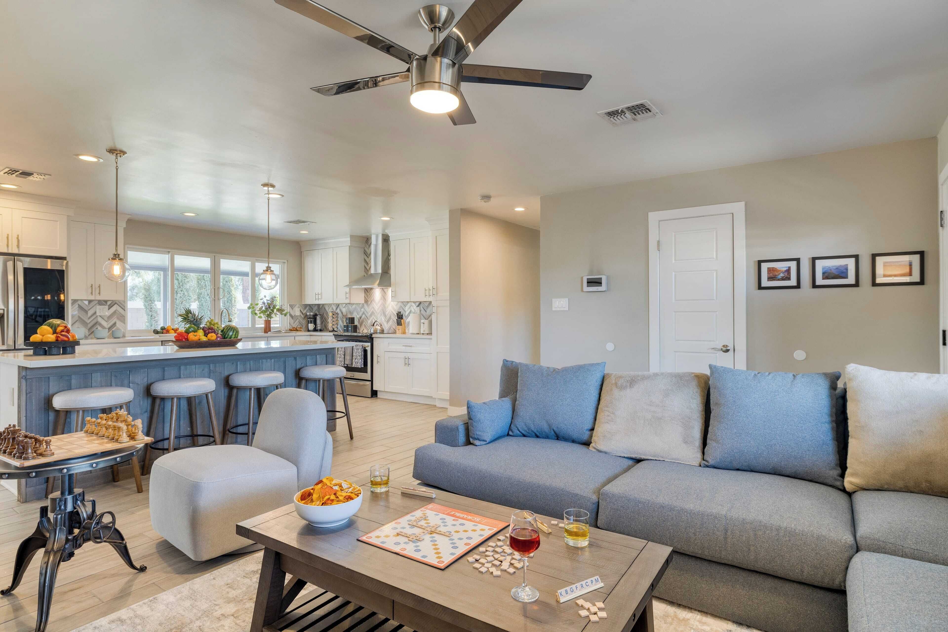 A modern living room with a sofa, coffee table, and a chessboard.