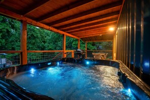 A hot tub area with a wooden roof and a view of trees. - Container in the Smokies! River/HotTub/FirePit (Sevierville)