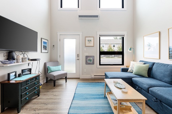 High ceilings, plush seating & sunlight pouring in create a bright, welcoming living space.