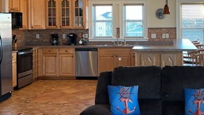 A kitchen with wooden cabinets, a dishwasher, and a coffee maker.