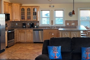 A kitchen with wooden cabinets, a dishwasher, and a coffee maker.