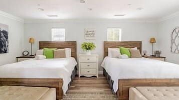 A double room with two beds, a nightstand, a bedside table, and a window.