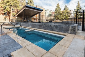 A rectangular swimming pool with a metal ladder and a safety sign indicating a depth of 3 feet.