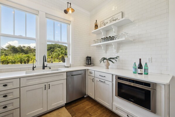 Full kitchen with stainless steel appliances: Gas stove top, oven, refrigerator, microwave, dishwasher, reverse osmosis water system, drip coffee maker, Nespresso machine, toaster, blender, crock pot, and fully stocked with all kitchen essentials.