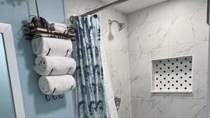 A bathroom with a toilet, sink, and shower.