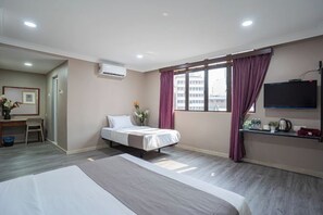 A hotel room with a large bed, a desk, a chair, a TV, and a window with curtains. - Hotel 28 Rapid (Kuala Lumpur)