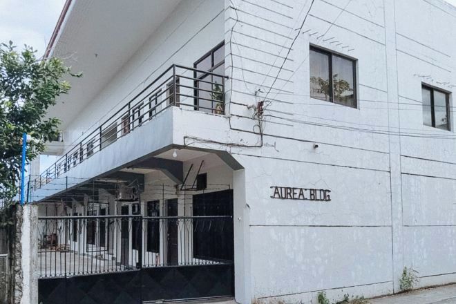 A two-story building with a balcony on the upper floor.