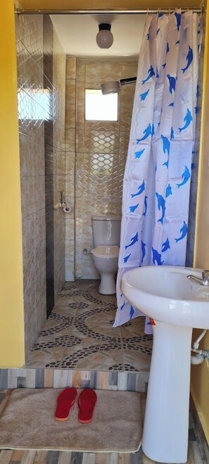Deluxe Double Room, Garden View | Bathroom | Shower, slippers, towels, soap - The Junction Resort Marigat (Marigat)