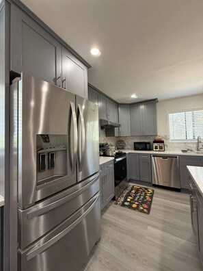 Dishwasher, coffee/tea maker, cookware/dishes/utensils, dining tables