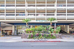A multi-story parking garage with a sign reading 'Island Colony 445 Seaside.'
