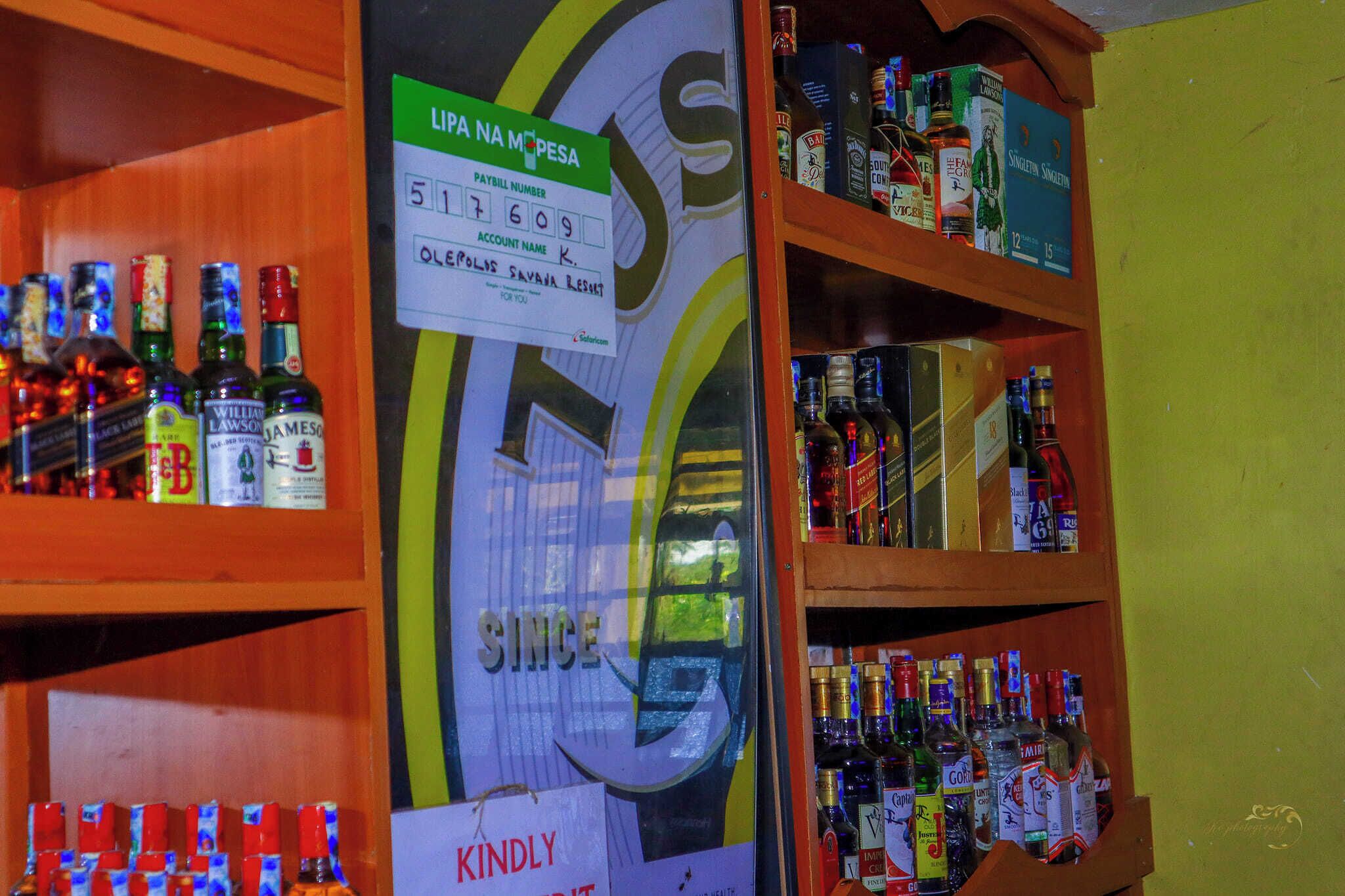 A liquor store with shelves stocked with various bottles and cans.