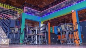 A multi-level restaurant with colorful walls and a wooden ceiling. - Ole Polos Resort Mogotio  (Mogotio)