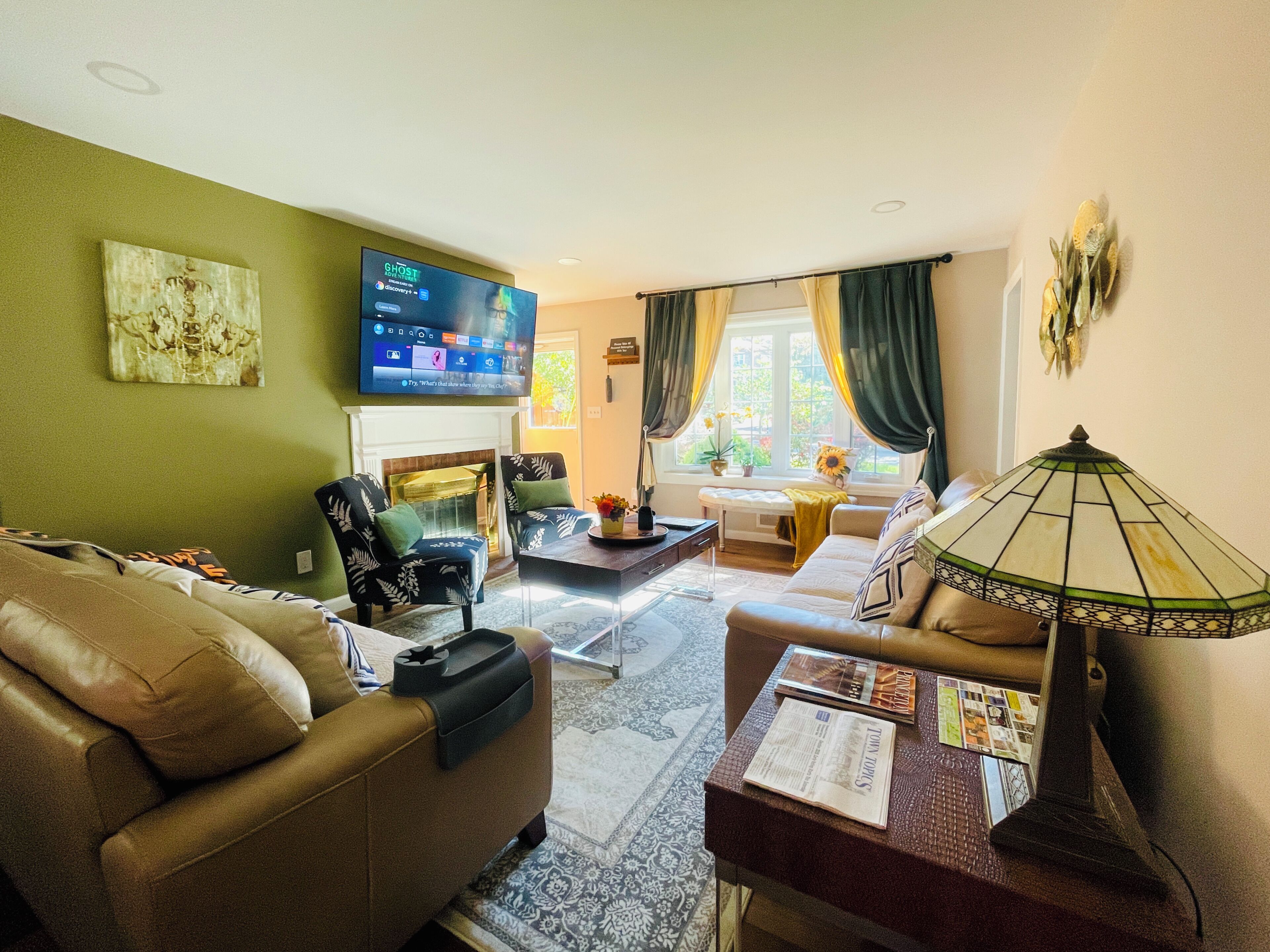 A living room with a fireplace, a television, and a sofa.
