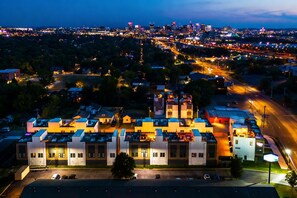 A large industrial building with multiple sections, surrounded by a parking lot and a road. - Rooftop fire pit house with pinball game room, sleeps 12 near Germantown (Nashville)