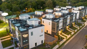 A modern apartment complex with multiple buildings, each featuring balconies and a central courtyard. - Nashville hot tub house sleeps 10, 3 bedrooms near Broadway (Nashville)