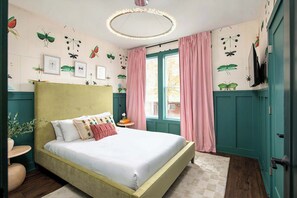 Themed bedroom with queen bed and playful wallpaper gives everyone their own retreat when it's time to rest
