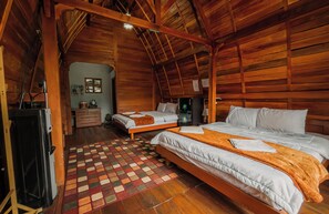 A cozy wooden cabin with two beds, a wooden floor, and a small kitchenette. - Omah Lumbung Nexura Escapes (Dieng Kulon)
