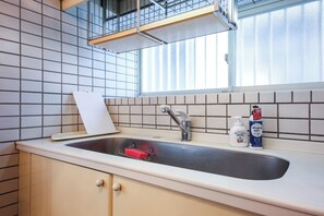 Kylskåp, mikrovågsugn, spishäll och grytor/köksredskap