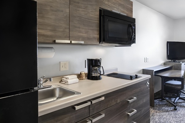 Cook and sip coffee easily with a stocked, modern kitchenette.
