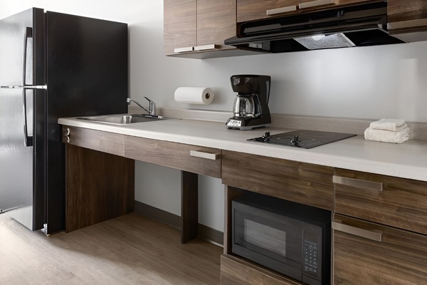 Prepare quick meals with sleek counters, microwave, and cooktop.