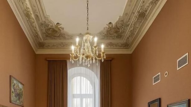 A hotel room with a large bed, a desk, a television, and a chandelier. - Bella Garden Hotel (Baku)